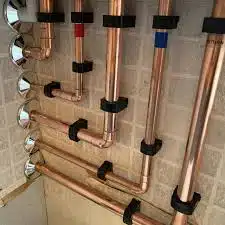 FM Products Black Clip Link Single Pipe Clips clipped to copper