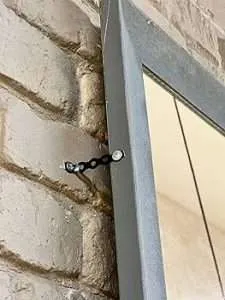 Galvanised Banding Builders All Round Steel Fixing Strap on a window